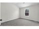 Bright bedroom with grey carpet and a window at 278 Deer Creek Run # 3-12, Moreland, GA 30259