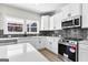 Modern kitchen with stainless steel appliances and dark gray tile backsplash at 278 Deer Creek Run # 3-12, Moreland, GA 30259
