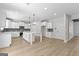 Modern kitchen with white cabinets, island, and stainless steel appliances at 278 Deer Creek Run # 3-12, Moreland, GA 30259