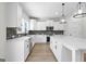 Modern kitchen with white cabinets, quartz countertops, and stainless steel appliances at 278 Deer Creek Run # 3-12, Moreland, GA 30259