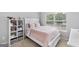 Charming bedroom with a twin bed and built-in shelving at 427 Blackbird Way, Hampton, GA 30228