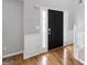Elegant entryway with hardwood floors and a black front door at 427 Blackbird Way, Hampton, GA 30228