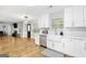 Modern kitchen with white cabinets, stainless steel appliances, and white farmhouse sink at 427 Blackbird Way, Hampton, GA 30228