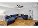 Open living room with sectional sofa, hardwood floors, and fireplace at 427 Blackbird Way, Hampton, GA 30228