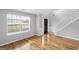 Spacious living room with hardwood floors and a large window at 427 Blackbird Way, Hampton, GA 30228