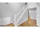 Bright entryway with hardwood floors and a staircase with white railing at 427 Blackbird Way, Hampton, GA 30228