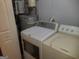 Stackable washer and dryer in laundry area with water heater at 3248 Brisbane Way, Lithonia, GA 30038