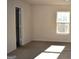 Bright bedroom with a window and an ensuite bathroom at 552 Moline Way, Locust Grove, GA 30248