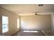 Living room with hardwood floors and two windows at 552 Moline Way, Locust Grove, GA 30248