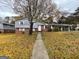 Brick ranch house with gray siding, landscaped yard, and walkway at 8819 Leafwood Ct, Riverdale, GA 30274