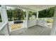 Charming front porch with wooden deck and white railings, offering a view of the street at 1222 Bronx Nw St, Atlanta, GA 30314