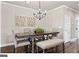 Bright dining room featuring hardwood floors and stylish light fixture at 5158 Noble Village Way # 35, Lilburn, GA 30047
