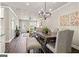 Open dining area with hardwood floors and access to kitchen at 5158 Noble Village Way # 35, Lilburn, GA 30047