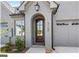 Inviting exterior with charming front door and attached garage at 5158 Noble Village Way # 35, Lilburn, GA 30047