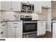 Stainless steel kitchen appliances, including a microwave and oven at 5158 Noble Village Way # 35, Lilburn, GA 30047