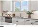 Modern kitchen sink with granite countertops and tile backsplash at 5158 Noble Village Way # 35, Lilburn, GA 30047