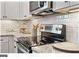 Modern kitchen stove with stainless steel finish at 5158 Noble Village Way # 35, Lilburn, GA 30047
