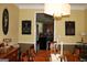 Elegant dining room with hardwood floors, a large table, and kitchen access at 9342 Carillon Ct, Jonesboro, GA 30236