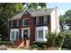 Brick two-story house with a welcoming front porch and landscaping at 9342 Carillon Ct, Jonesboro, GA 30236