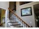 Elegant staircase with wrought iron railings and hardwood steps at 9342 Carillon Ct, Jonesboro, GA 30236