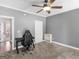 Gray bedroom with a desk, chair, and built-in shelving at 225 Crumbley Rd, Mcdonough, GA 30252