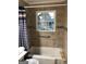 Bathroom with beige tile and shower/tub combo at 1110 1St Nw St, Atlanta, GA 30318