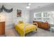 Cozy bedroom with yellow bedding and mid-century dresser at 2270 Emerald Drive, Jonesboro, GA 30236