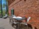 Deck with table and chairs, adjacent to brick wall at 2270 Emerald Drive, Jonesboro, GA 30236