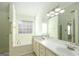 Double vanity bathroom with a large mirror and soaking tub at 302 Preston Chase Dr, Peachtree City, GA 30269