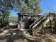 Back exterior of house with wooden deck and stairs leading to the ground at 361 Almon Rd, Covington, GA 30014