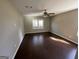 Bright bedroom with dark hardwood floors and ceiling fan at 361 Almon Rd, Covington, GA 30014