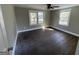 Bedroom with dark hardwood floors and two windows at 361 Almon Rd, Covington, GA 30014