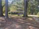 Gray house with light blue door, a long driveway, and large trees in the front yard at 361 Almon Rd, Covington, GA 30014