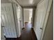 Long hallway with hardwood floors and access to bedrooms at 361 Almon Rd, Covington, GA 30014