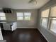Kitchen with white cabinets, granite countertops, and dark hardwood floors at 361 Almon Rd, Covington, GA 30014