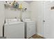 Laundry room with washer, dryer, and overhead shelving at 11075 Shadow Ct, Hampton, GA 30228