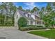 Two-story house with a wraparound porch and driveway, nestled among lush greenery at 100 Dresden Pl, Fayetteville, GA 30215