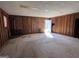 Unfinished basement with wood paneling and a stone fireplace at 779 Dial Mill Rd, Oxford, GA 30054