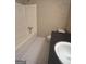 Clean bathroom with a bathtub, toilet and vanity with dark countertop at 779 Dial Mill Rd, Oxford, GA 30054