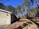 Side view of the house showcasing a wooded backdrop at 779 Dial Mill Rd, Oxford, GA 30054