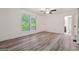 Bright bedroom with hardwood flooring, white walls, large window, ceiling fan, and attached bathroom at 344 Rocky Creek Rd, Hampton, GA 30228