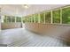 Enclosed porch with multiple windows bringing the beauty of the outdoors inside at 344 Rocky Creek Rd, Hampton, GA 30228