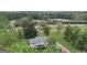 Aerial view of house with deck, spacious yard, and nearby road at 9782 Highway 166, Winston, GA 30187