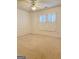 Bright bedroom with neutral carpeting, plantation shutters and ceiling fan at 100 Kindlehurst Dr, Tyrone, GA 30290