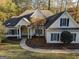 Two-story house with a yellow door, grey shutters and a landscaped yard at 100 Kindlehurst Dr, Tyrone, GA 30290