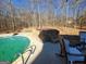 Hot tub nestled in the backyard near the pool at 1497 Cross Plains Hulett Rd, Carrollton, GA 30116