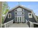 Gray barn-style home with a large deck and surrounding trees at 460 Dixie Rd, Covington, GA 30014