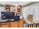 Home office with built-in shelving and large windows at 460 Dixie Rd, Covington, GA 30014