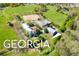 Aerial view of a large estate with horse stables and riding arena at 460 Dixie Rd, Covington, GA 30014