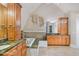 Elegant bathroom with a large soaking tub, granite countertops and wood cabinets at 460 Dixie Rd, Covington, GA 30014